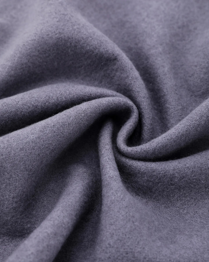 A close-up of draped gray fabric with a soft, slightly fuzzy texture, arranged in a spiral fold pattern.#color_silver