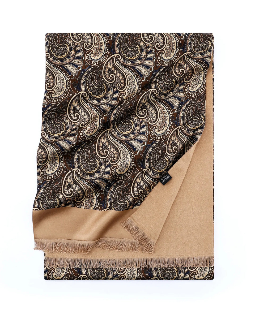 A folded luxury scarf featuring a dark brown and beige paisley pattern on one side and a solid tan reverse side with fringed edges, displayed on a clean white background.#color_antique-gold
