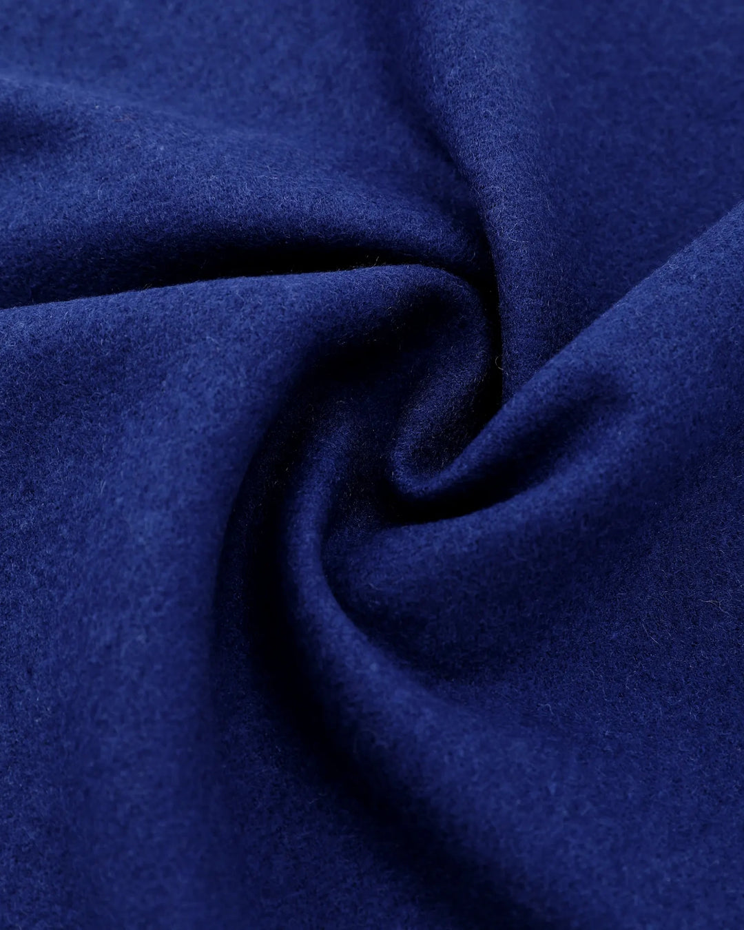 A close-up of deep blue fabric with a soft, slightly fuzzy texture, arranged in a spiral drape pattern.#color_navy-blue