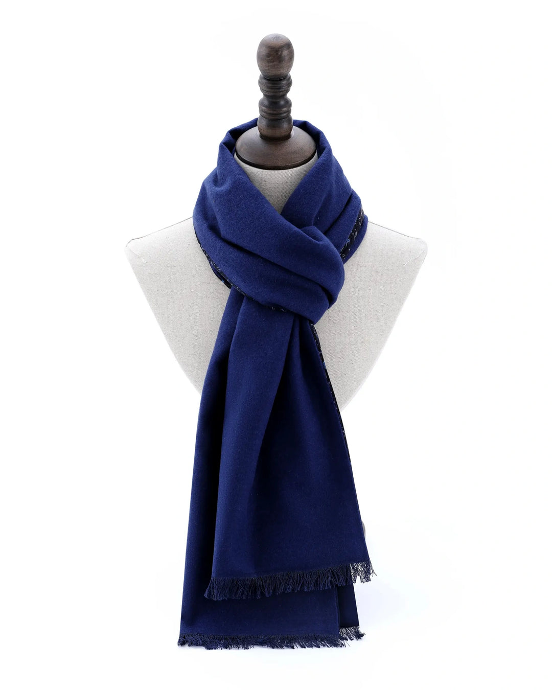 A navy blue scarf with fringed edges, styled on a white dress form mannequin against a plain white background.#color_navy-blue