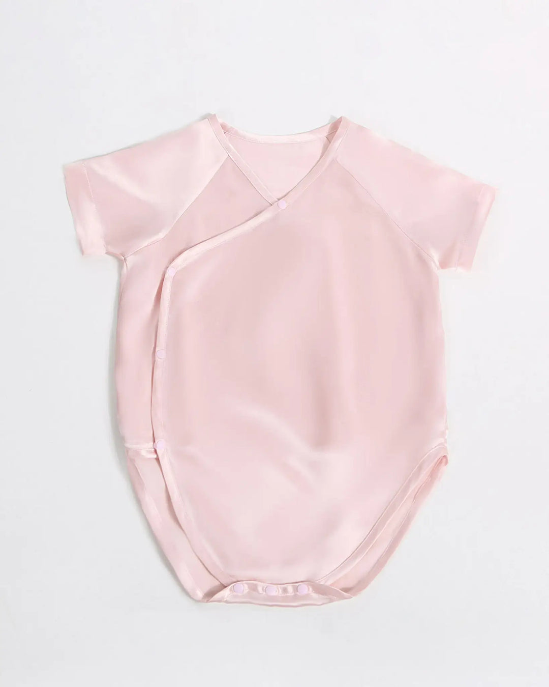 Blush pink baby kimono bodysuit made from hypoallergenic 19 momme mulberry silk with soft breathable texture