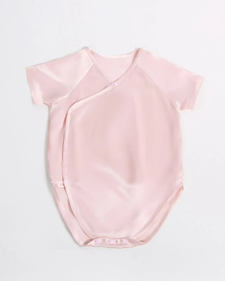 Blush pink baby kimono bodysuit made from hypoallergenic 19 momme mulberry silk with soft breathable texture