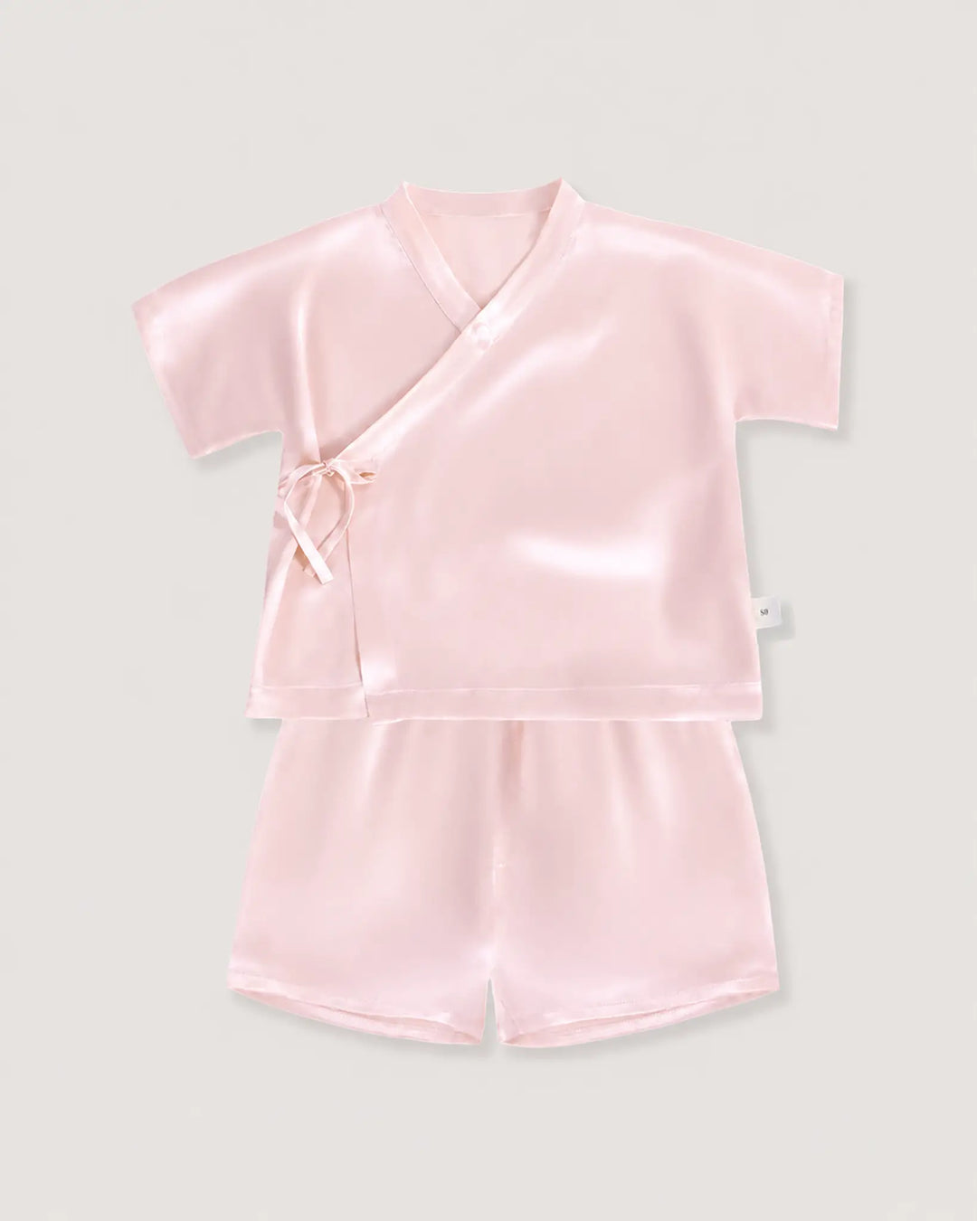 Blush pink silk baby pajama set with soft kimono wrap top and lightweight silk shorts for comfortable sleep