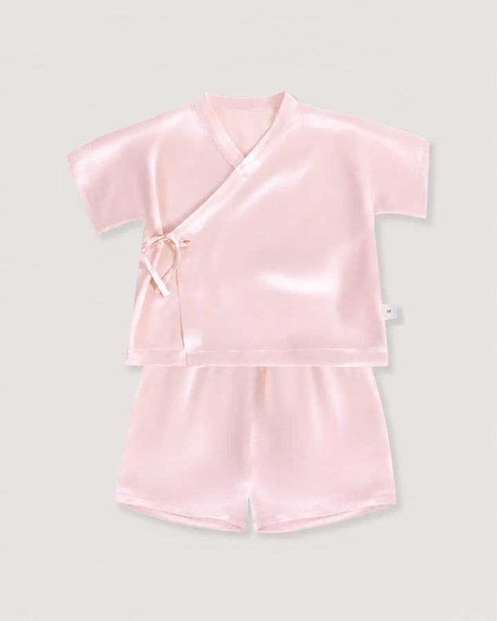 Blush pink silk baby pajama set with soft kimono wrap top and lightweight silk shorts for comfortable sleep