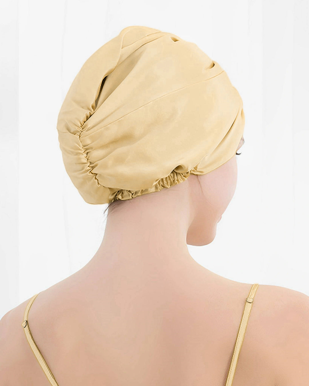 Back view of model wearing double layer mulberry silk sleep bonnet, fully lined silk design suitable for thick and long hair
