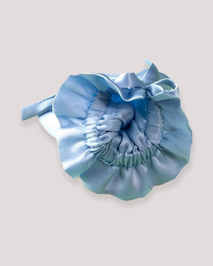 Interior view of blue baby silk mittens showing the soft elastic wrist construction and smooth mulberry silk fabric for delicate infant skin.