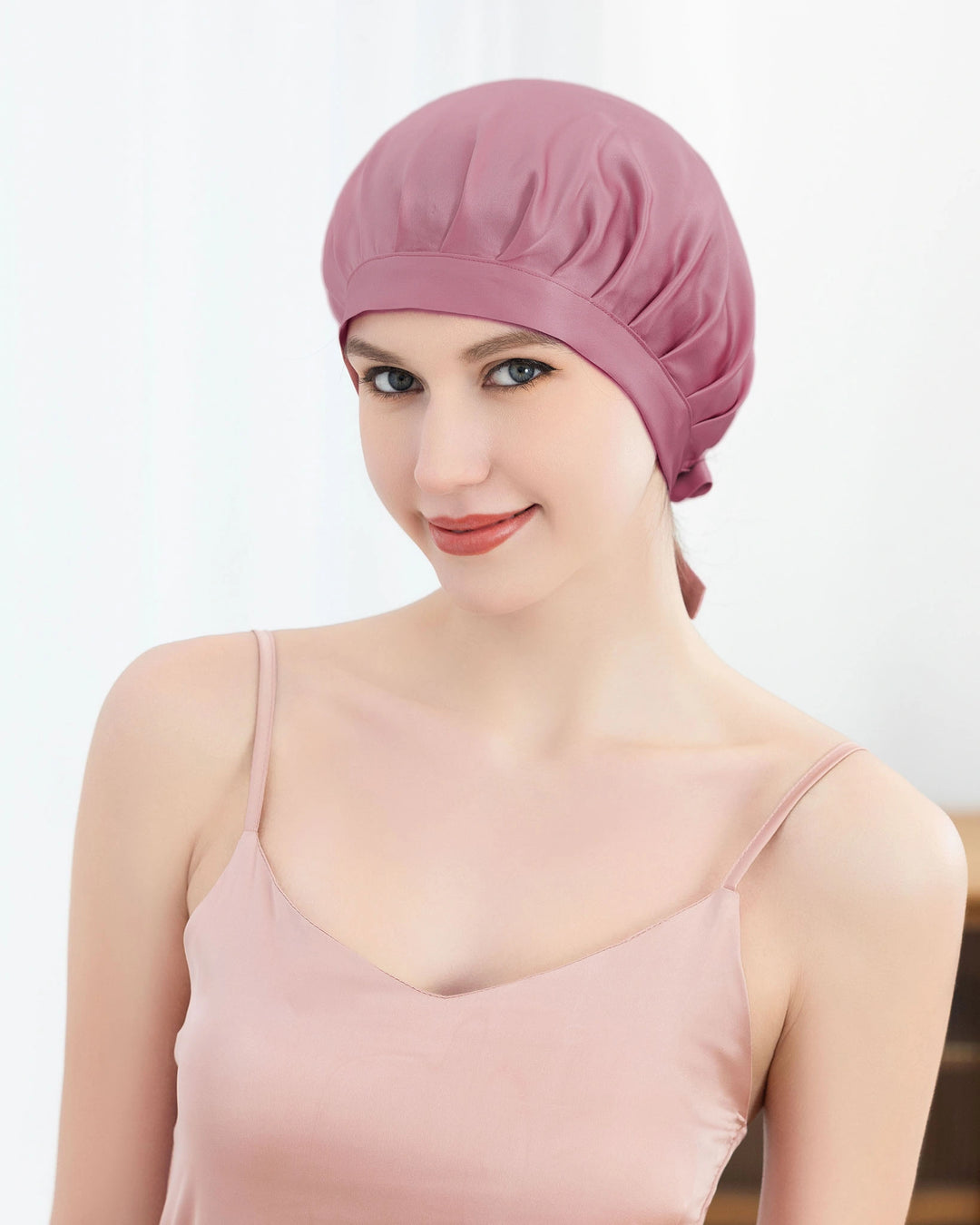 Model wearing luxury mulberry silk tie back sleep bonnet, lightweight elegant design suitable for all hair types