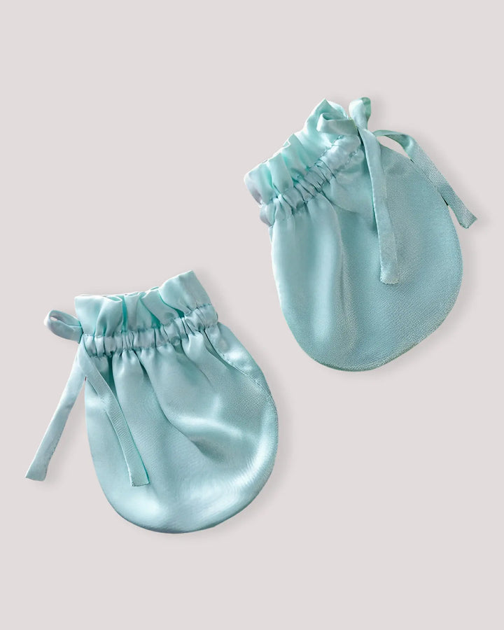 Pair of mint green 19 Momme mulberry silk baby mittens with breathable natural silk and a secure elastic closure for newborn anti-scratch protection.