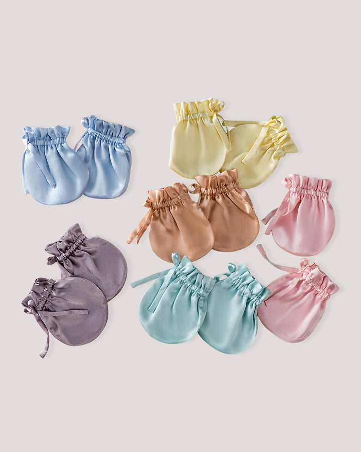 Collection of pastel-colored baby silk mittens made from 100% mulberry silk, providing breathable comfort and gentle protection against face scratching.