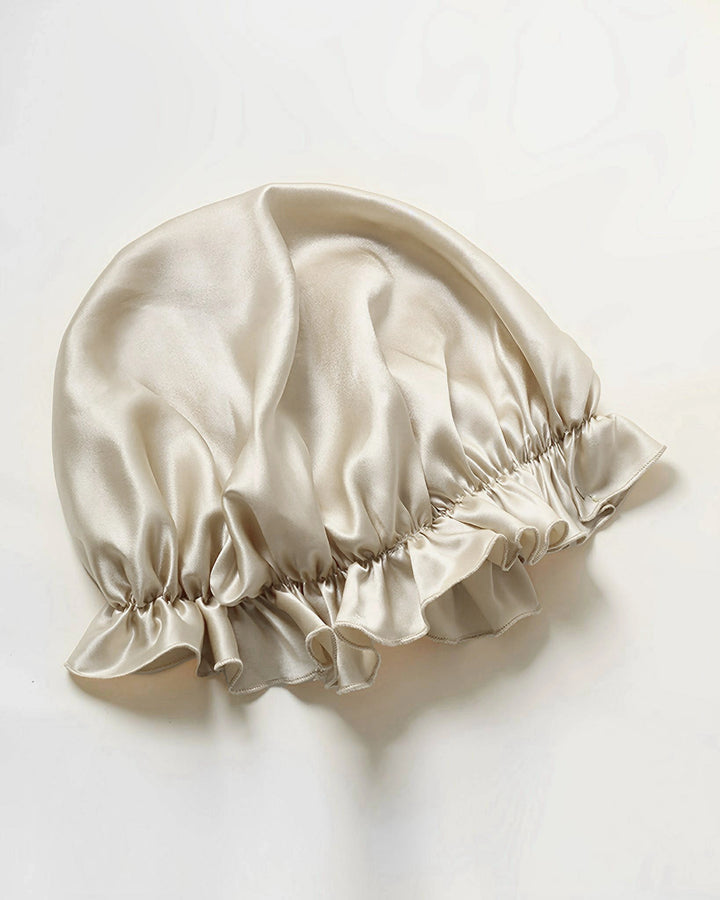 Silver gray mulberry silk ruffled sleep bonnet laid flat, smooth breathable silk bonnet with elastic ruffle edge