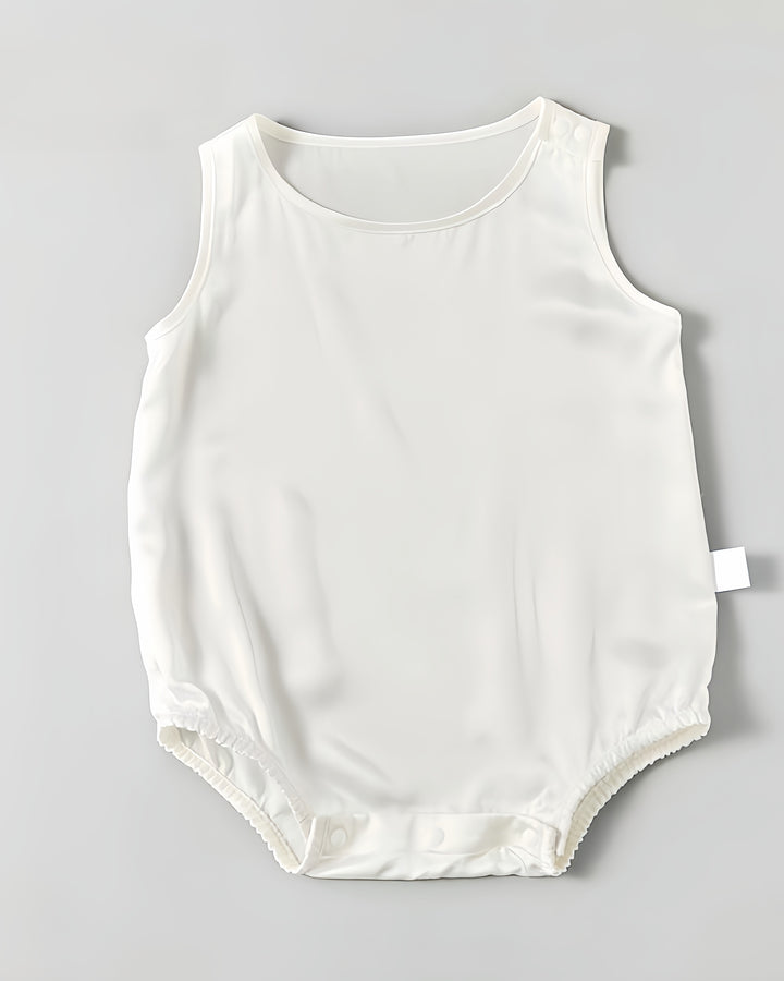 A sleeveless 19 Momme Silk Baby Button Onesie from SusanSilk, displayed flat on a gray background, with a sleek white design featuring snaps at the bottom for easy fastening.
