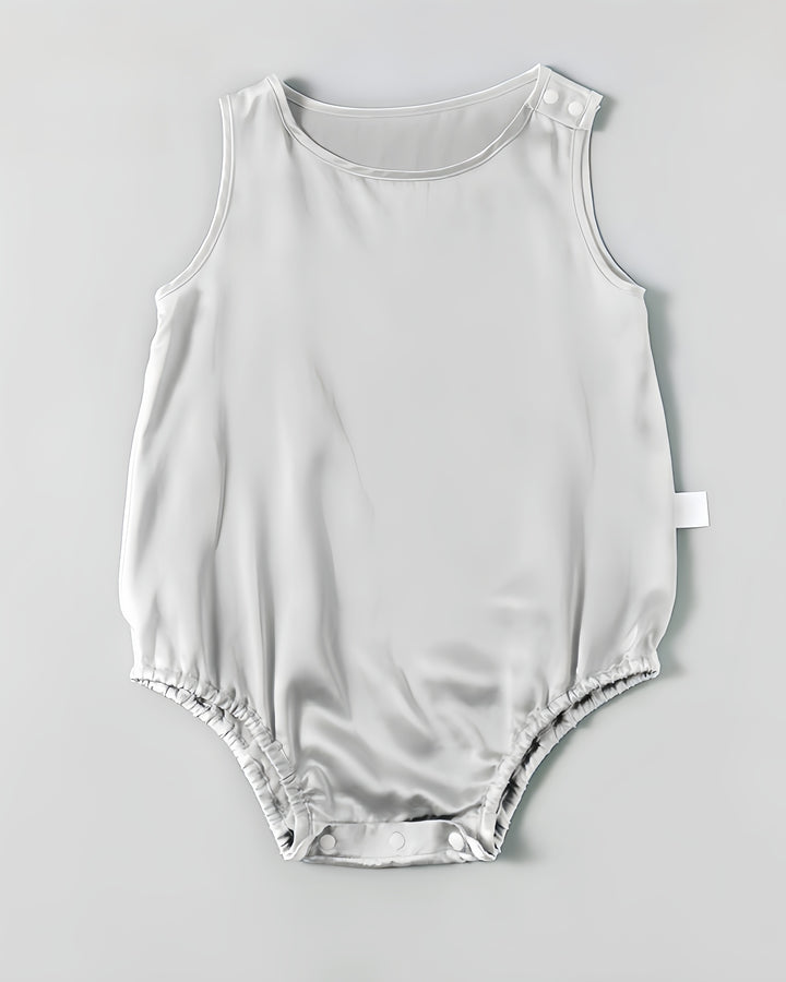 The 19 Momme Silk Baby Button Onesie by SusanSilk is a light gray, sleeveless romper featuring snap buttons on the shoulder and at the bottom, crafted from a luxurious silk blend for added comfort.