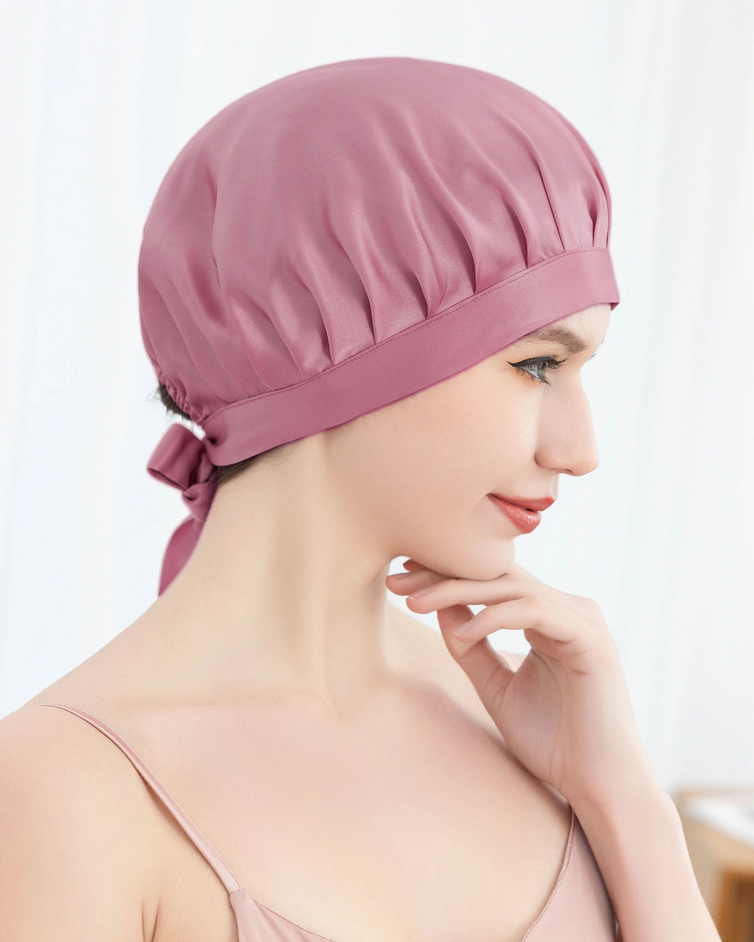 Model wearing tie back mulberry silk sleep bonnet featuring adjustable ribbon design, smooth double layer silk for comfort