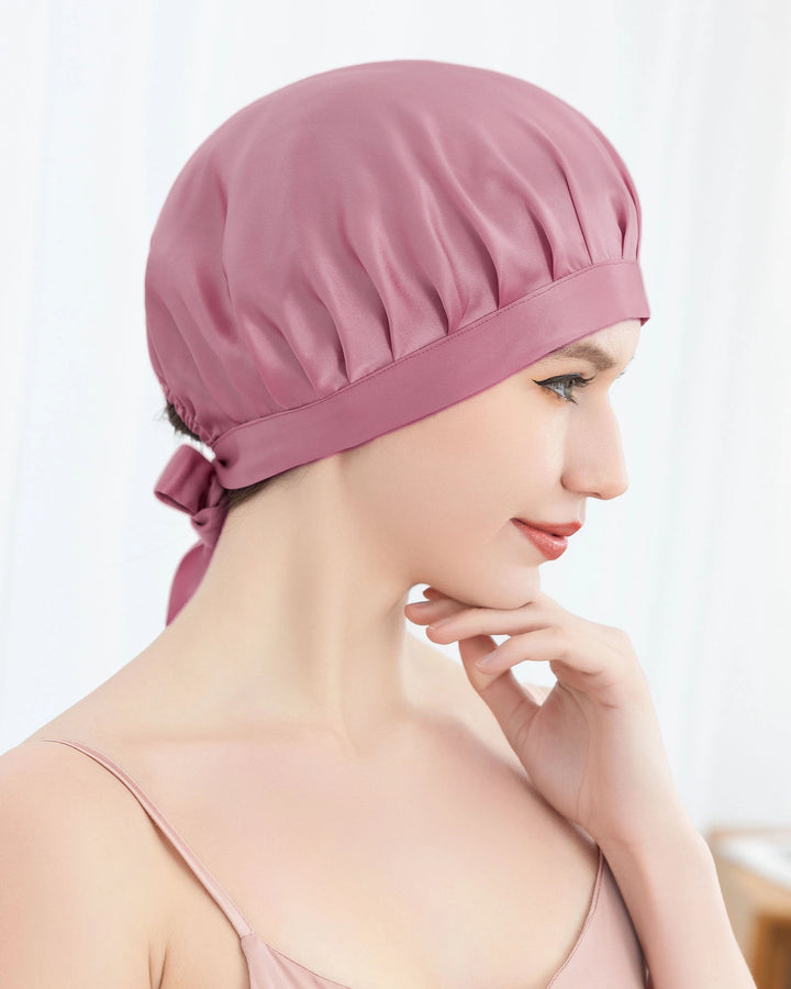 Model wearing tie back mulberry silk sleep bonnet featuring adjustable ribbon design, smooth double layer silk for comfort