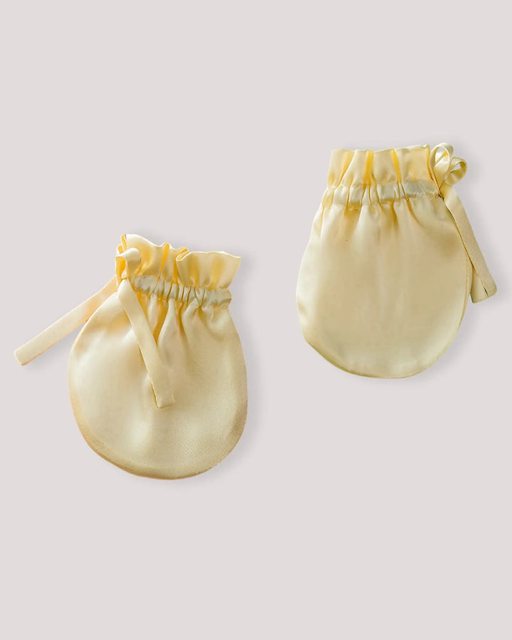 Pair of yellow baby silk anti-scratch mittens crafted from 19 Momme mulberry silk for breathable comfort and gentle newborn hand protection.