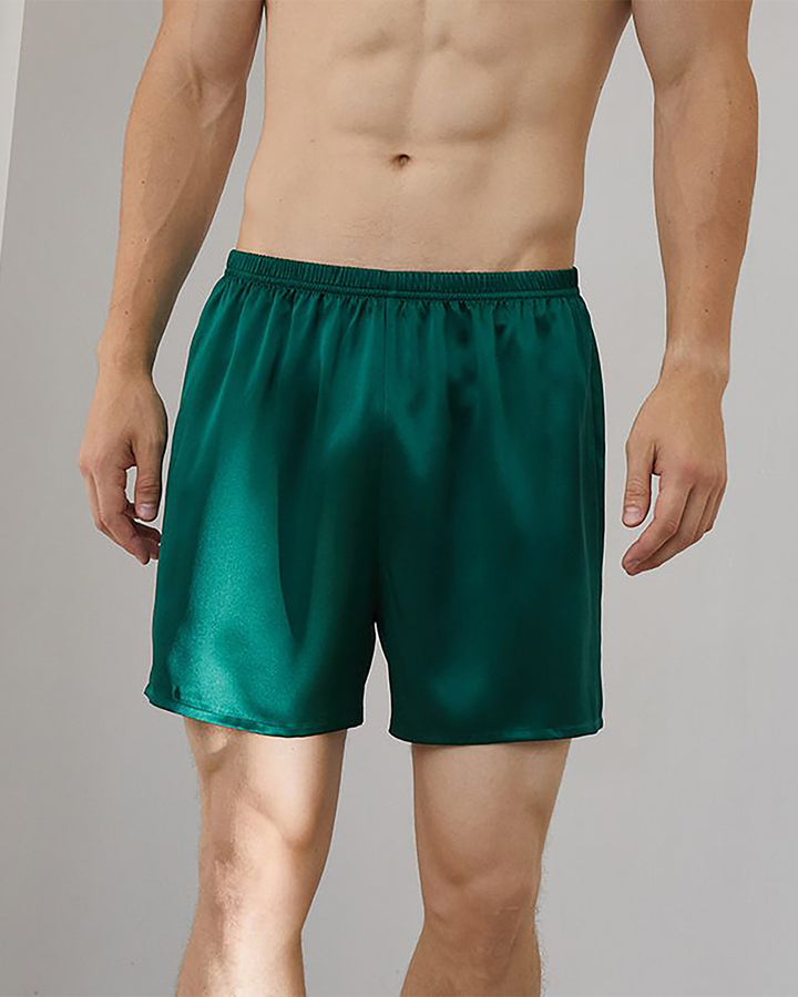 A shirtless person is shown wearing the dark green 19 Momme Comfortable Silk Boxer by SusanSilk.
