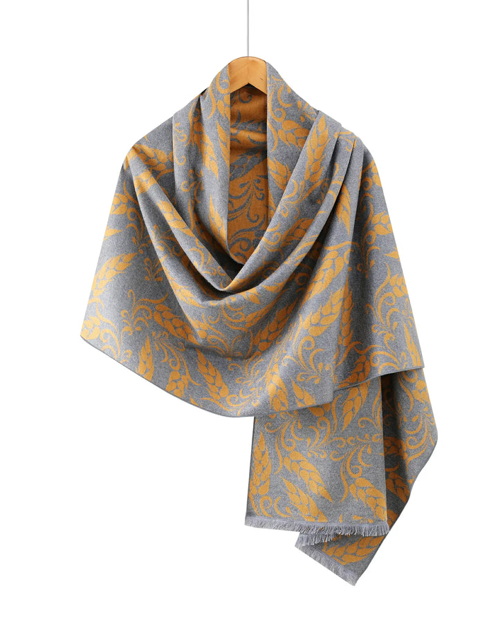 Gray and yellow patterned scarf on a wooden hanger against a white background