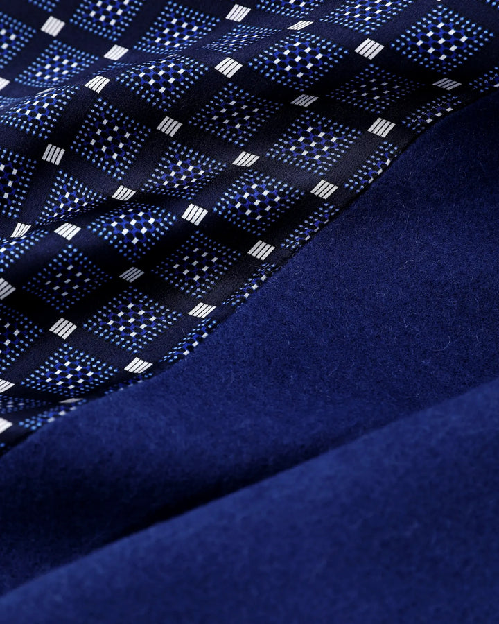 Close up view of navy blue silk scarf showing refined geometric grid pattern and smooth satin silk texture.#color_navy-blue