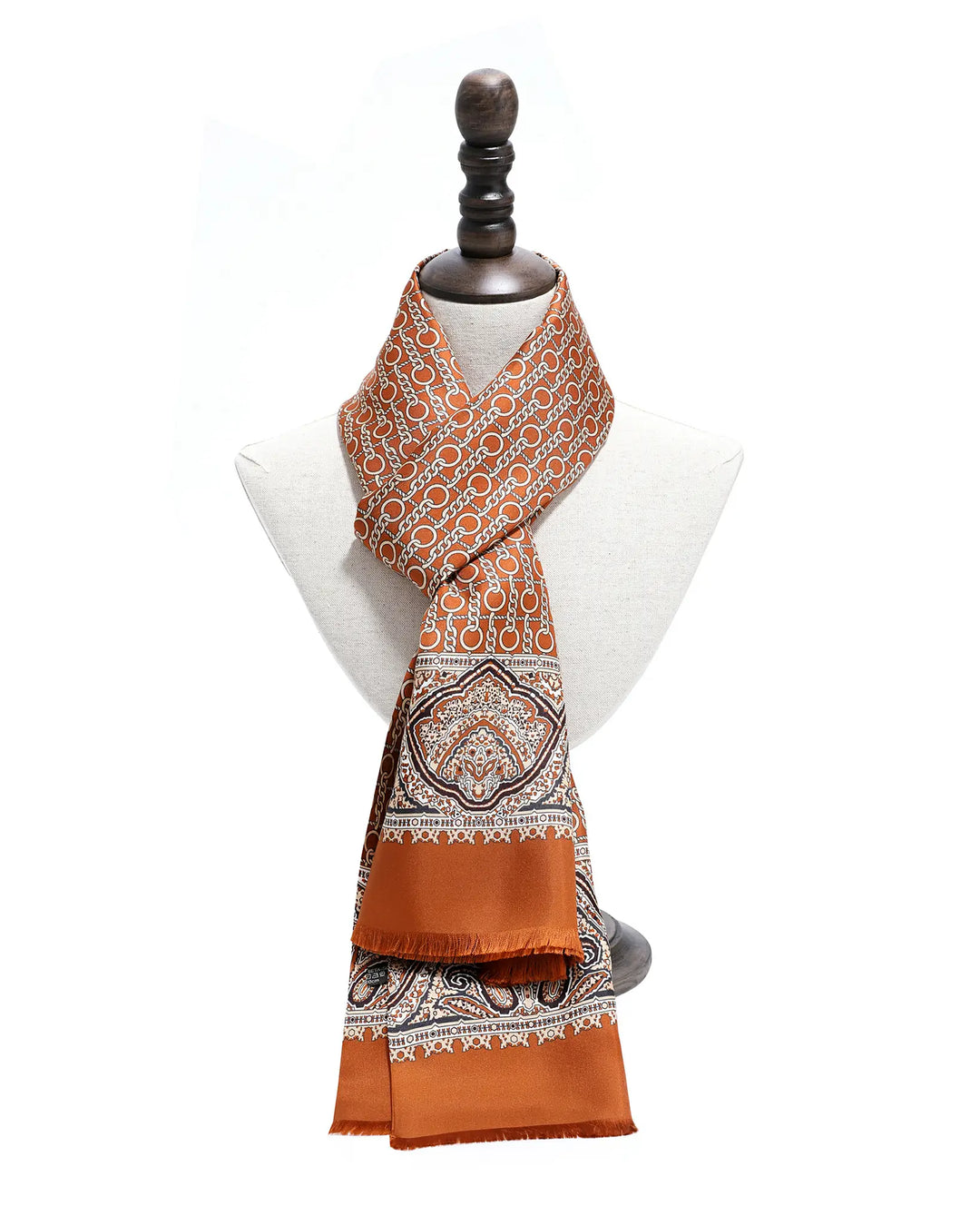 Orange patterned scarf on a mannequin against a white background.#color_cinnamon
