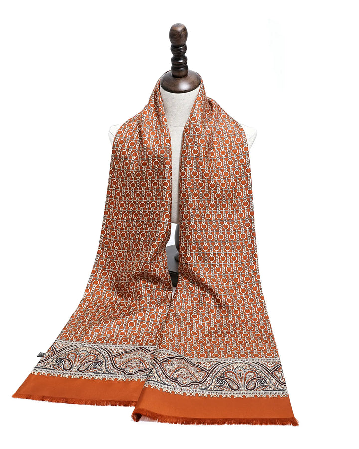 Orange patterned scarf on a mannequin against a white background.#color_cinnamon