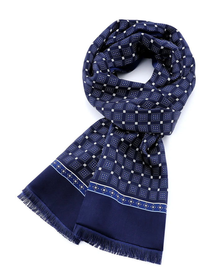 Navy blue mulberry silk scarf styled around the neck with elegant geometric grid pattern and tassel edges.#color_navy-blue