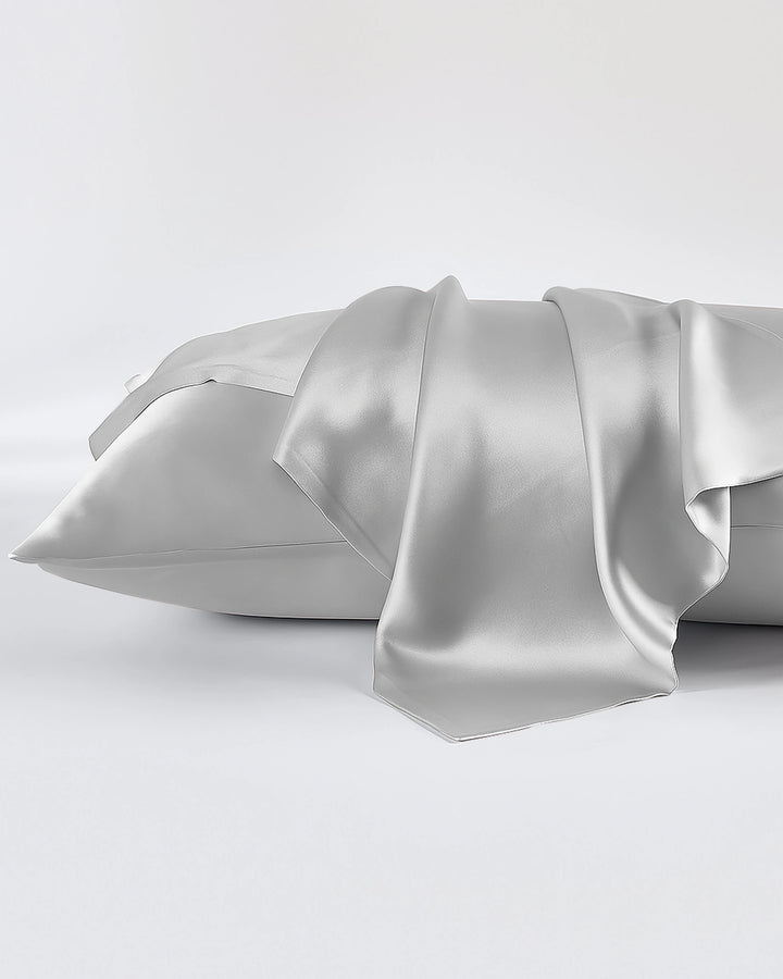 Silver satin pillowcase on a white background