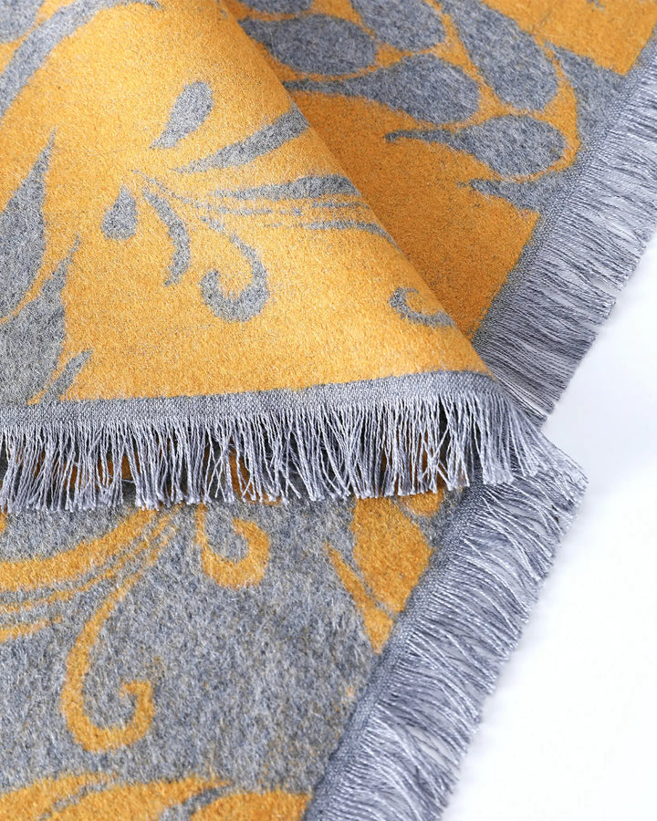 Close-up of a patterned fabric with yellow and gray colors on a white background