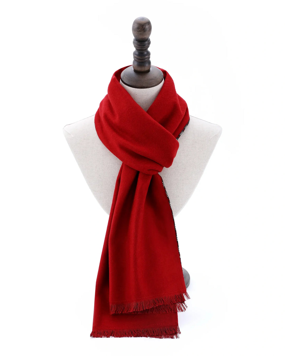 A vibrant red scarf with fringed edges, styled on a white mannequin bust with a dark wooden neck stand against a plain white background.#color_wine-red
