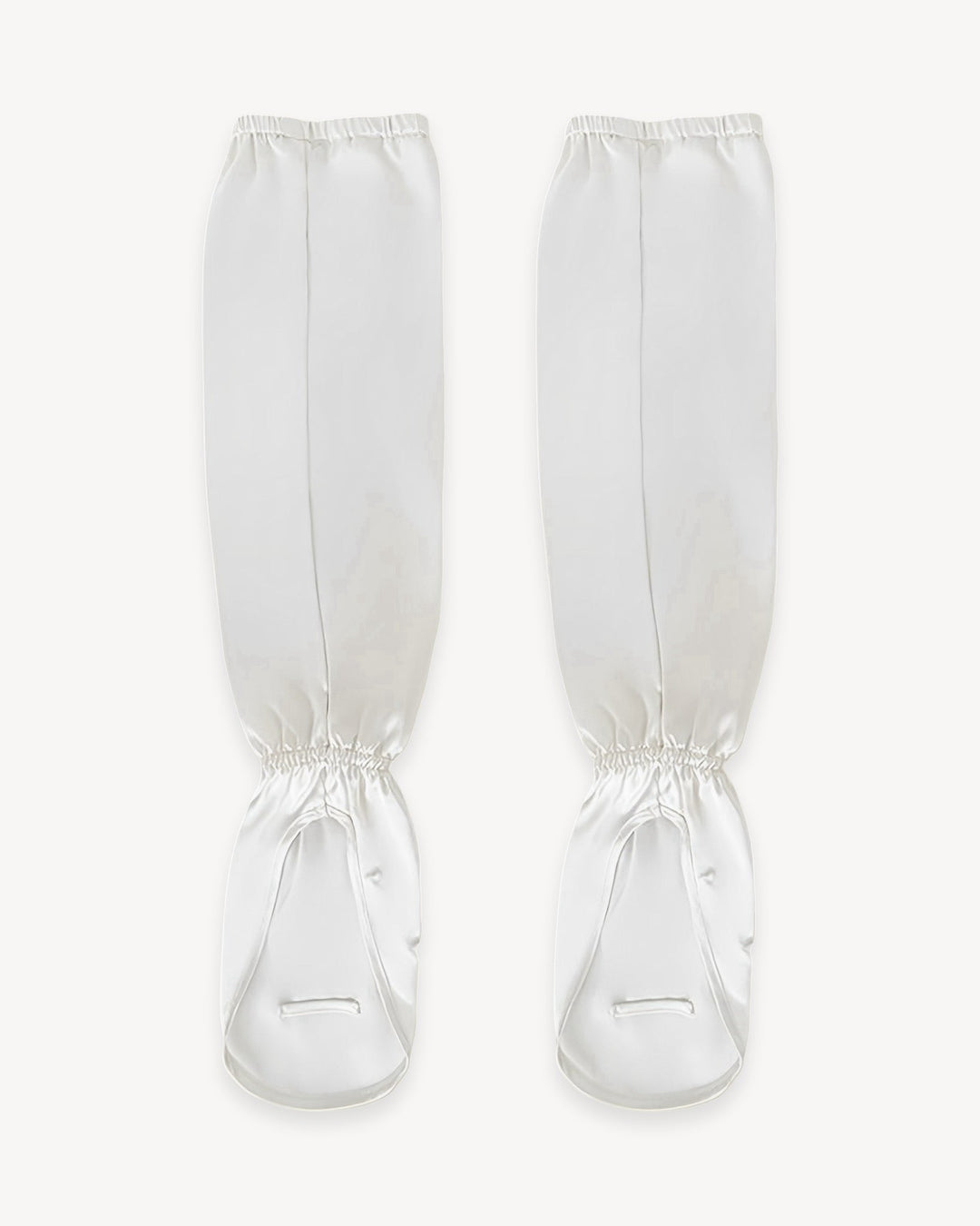 Introducing the Sun Protection Silk Over Sleeves by SusanSilk, a pair of white silk accessories designed with straps, shown front-facing, perfect for securing and protecting your lower legs.