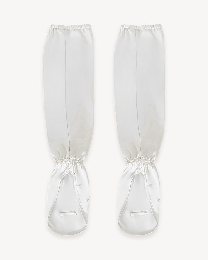 Introducing the Sun Protection Silk Over Sleeves by SusanSilk, a pair of white silk accessories designed with straps, shown front-facing, perfect for securing and protecting your lower legs.