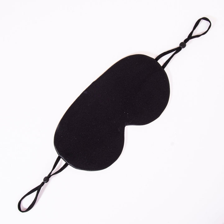 The Earth Tones Double Side Silk Eye Mask by SusanSilk in black, featuring adjustable straps, is designed to cover the eyes and block light for restful sleep.