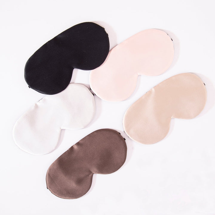 Five Earth Tones Double Side Silk Eye Masks from SusanSilk are laid out on a flat surface in an arc, showcasing shades of black, light pink, beige, white, and brown. Each mask is crafted from luxurious susansilk for a soft and comfortable feel.