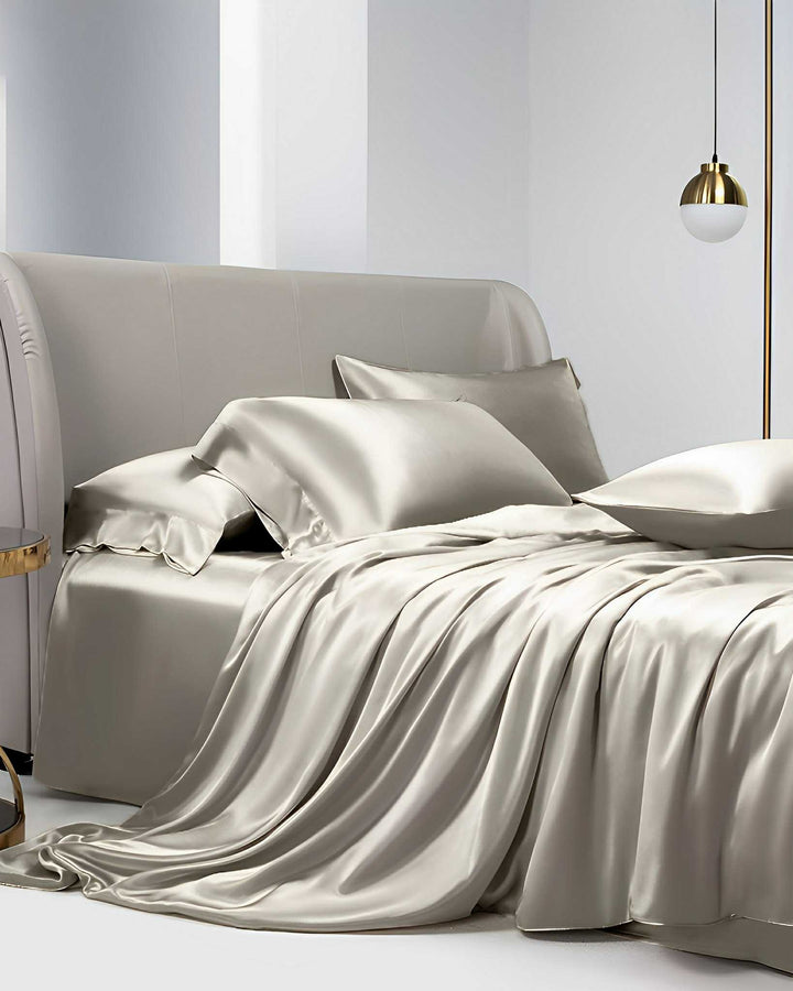Luxurious bedroom featuring the 19 Momme Moisturizing Silk Bedding Set - 4Pcs from SusanSilk, complete with silky smooth sheets, matching pillows, and a sleek, modern design, complemented by a gold-accented pendant light.