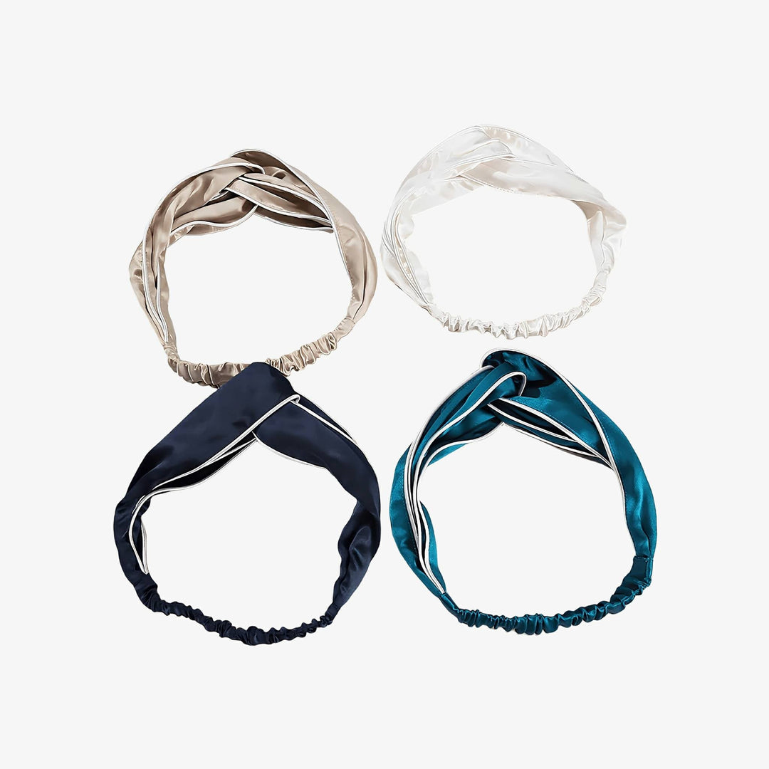 The Piping Criss Cross Silk Headbands by SusanSilk are arranged in a square with the colors, from top left clockwise, being beige, white, teal, and navy blue. Each headband includes an elastic section.