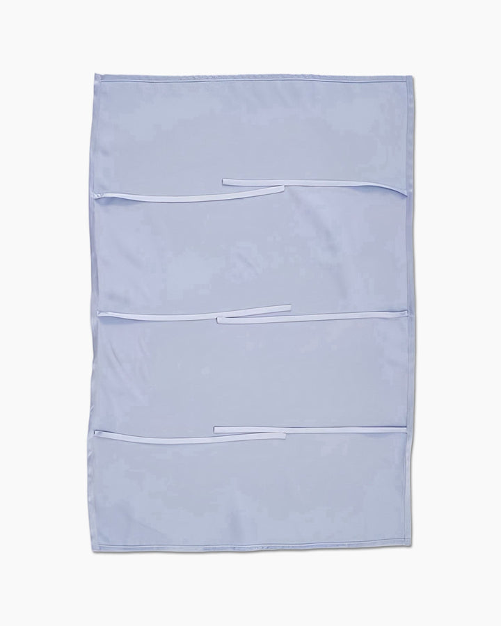 A light blue SusanSilk fabric wall organizer featuring three horizontal pockets and two loops on each pocket for attaching items.