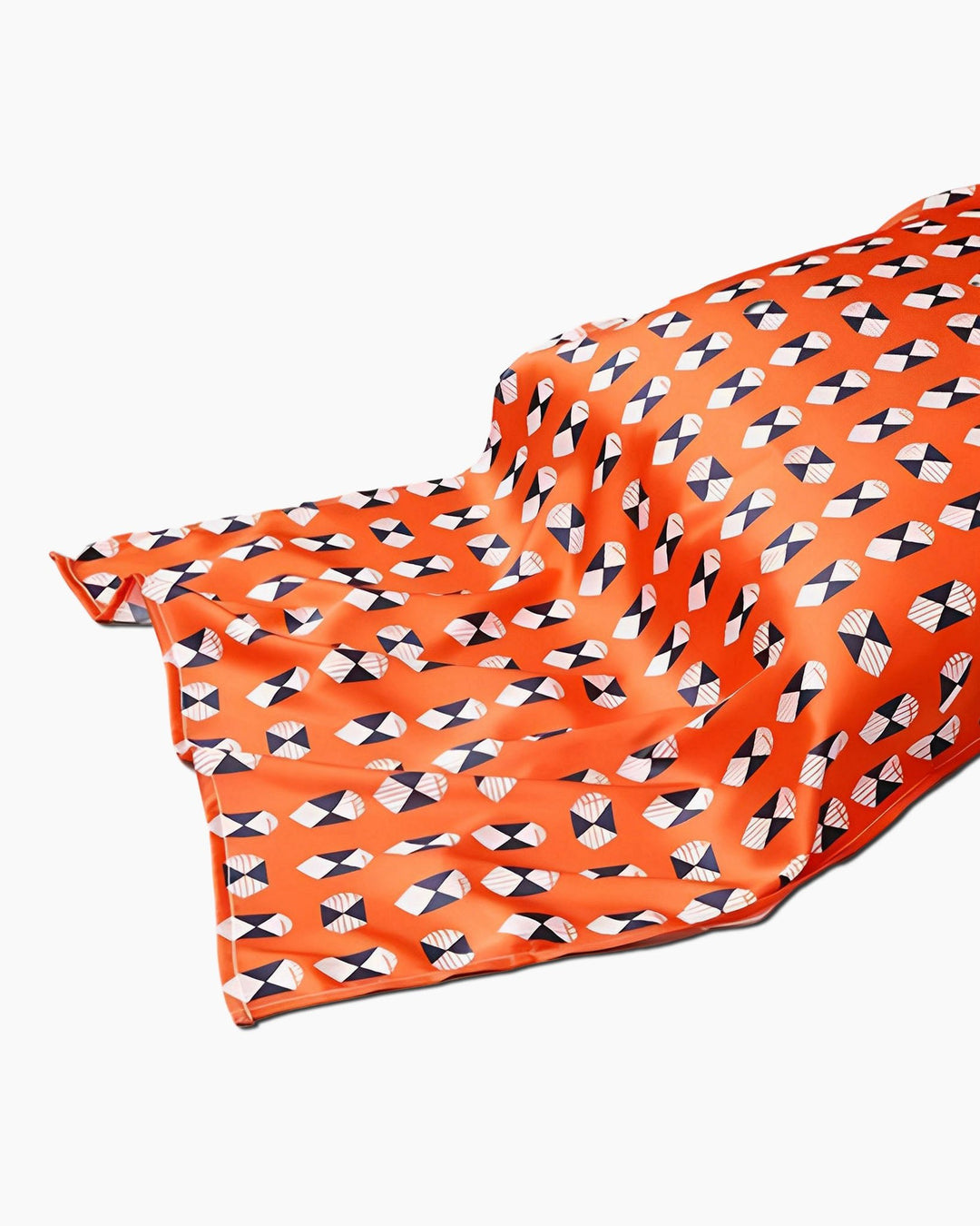The 19 Momme Printing Silk Pillow Cover from SusanSilk, featuring a geometric pattern with small black and white shapes, is draped over an unseen surface.