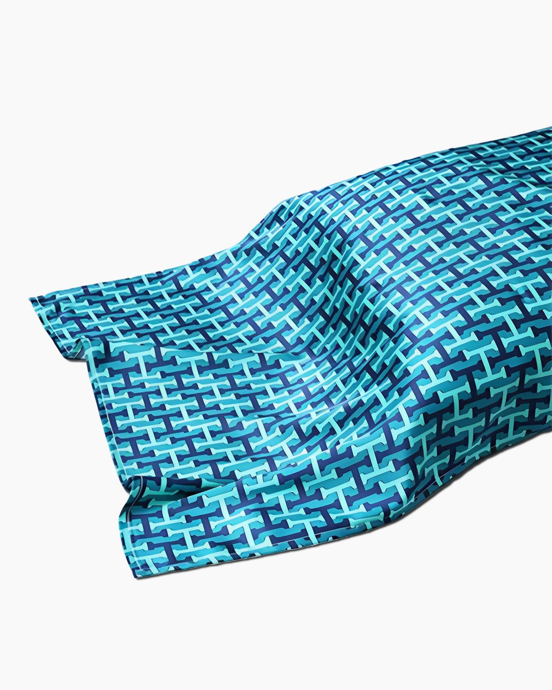 A 19 Momme Printing Silk Pillow Cover from SusanSilk is displayed, featuring an interlocking geometric design in blue and teal on a white background, reminiscent of luxurious beach towels.