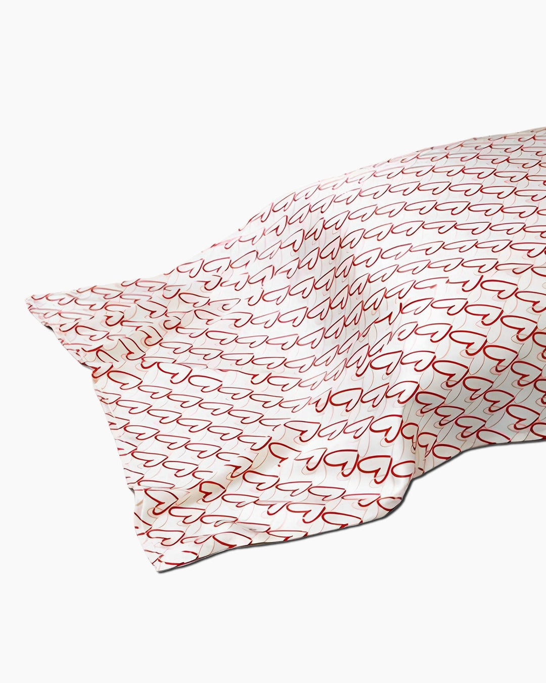 A 19 Momme Printing Silk Pillow Cover from SusanSilk, featuring a white fabric with a repeated pattern of red outline hearts.