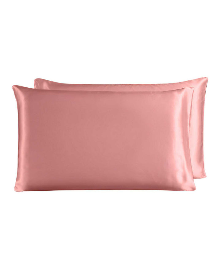 Two 19 Momme Silk Pillowcase Zippers in pink are displayed, one placed slightly behind the other, exuding an aura of pure luxury reminiscent of fine silk from SusanSilk.