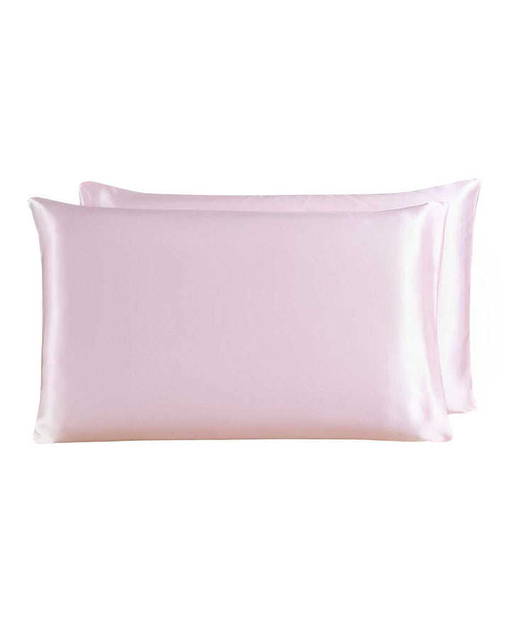 Two light pink SusanSilk 19 Momme Silk Pillowcase Zippers with a smooth and shiny texture.