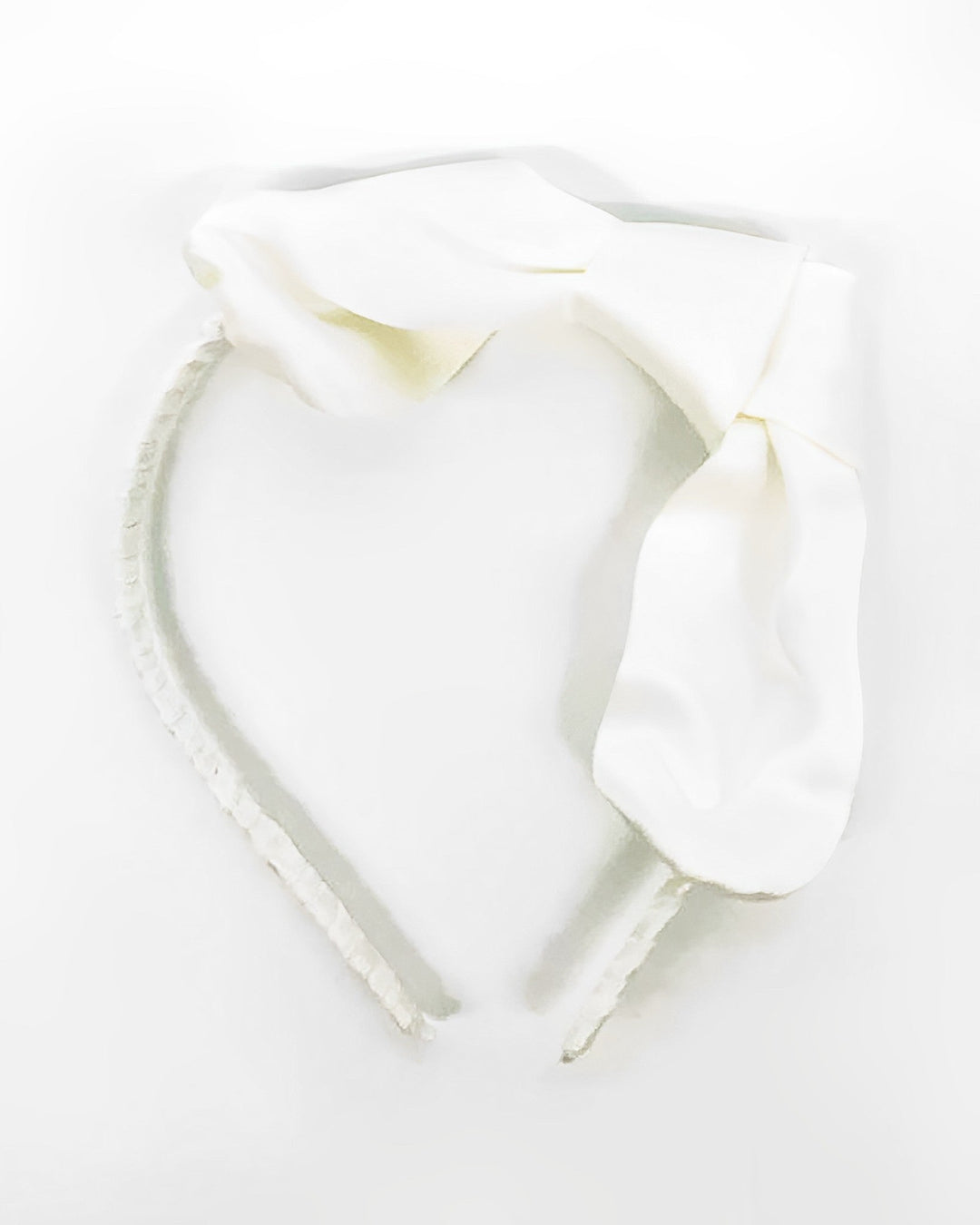 The Pure Color Bow Knot Silk Headband from SusanSilk, featuring a large silk bow and a white color, is displayed against a plain white background.