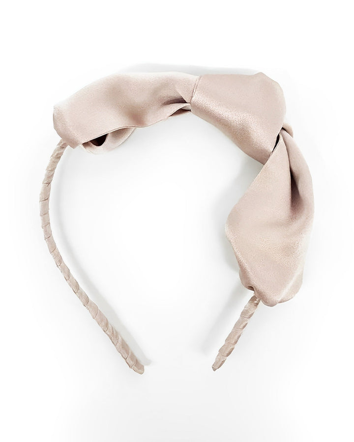 A light beige headband from SusanSilk, featuring a textured design and a large bow on top, known as the Pure Color Bow Knot Silk Headband.