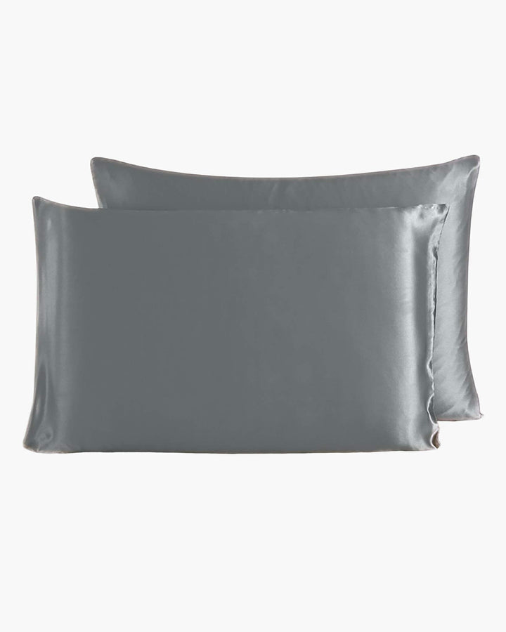 Two luxurious SusanSilk 22 Momme Beauty Silk Pillowcase Zippers in gray are shown, one slightly overlapping the other, set against a pristine white background.