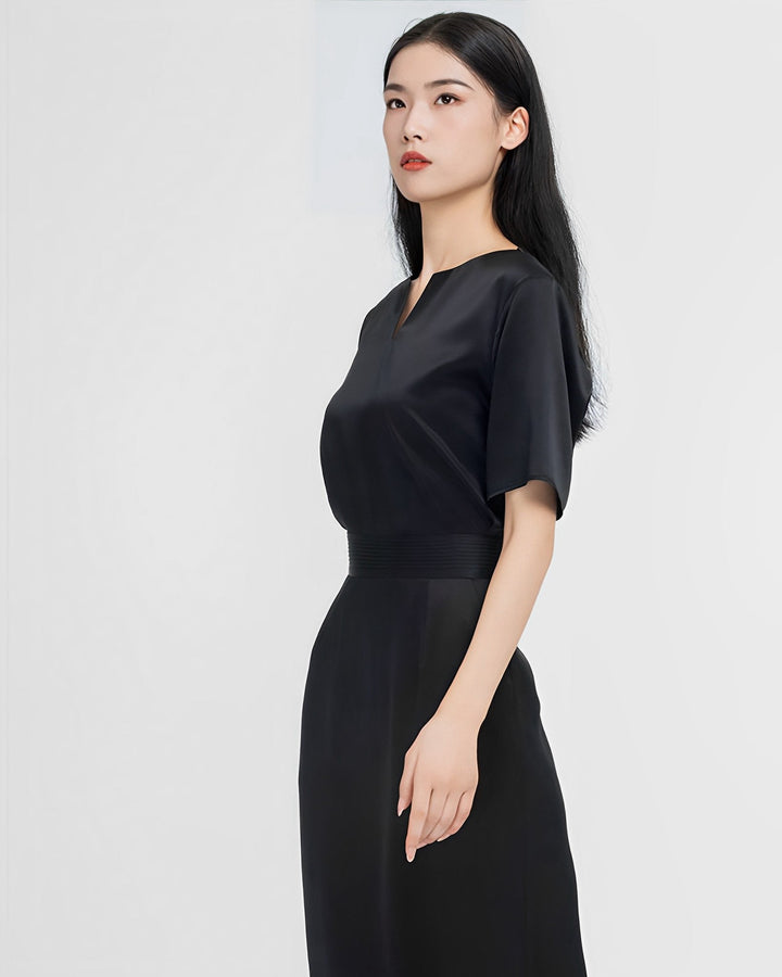 A woman with long black hair is standing and looking slightly to the side. She is wearing the Elegant Two-Piece Silk Dress Set from SusanSilk. The background is plain white.