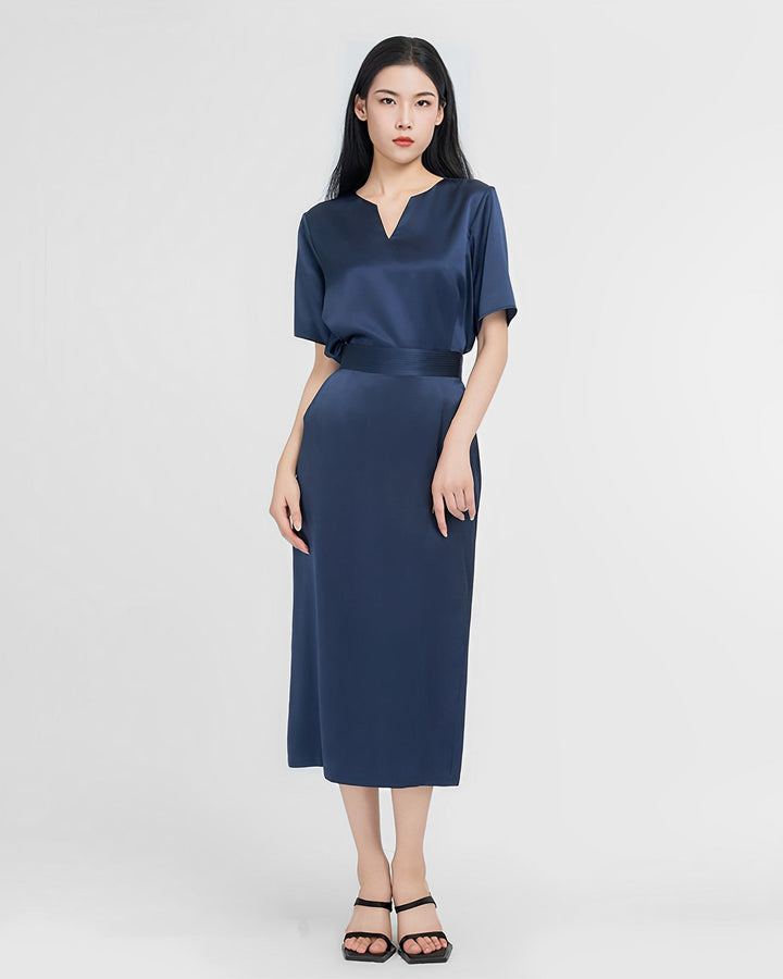 A woman stands against a plain background, elegantly dressed in an Elegant Two-Piece Silk Dress Set from SusanSilk and black sandals.