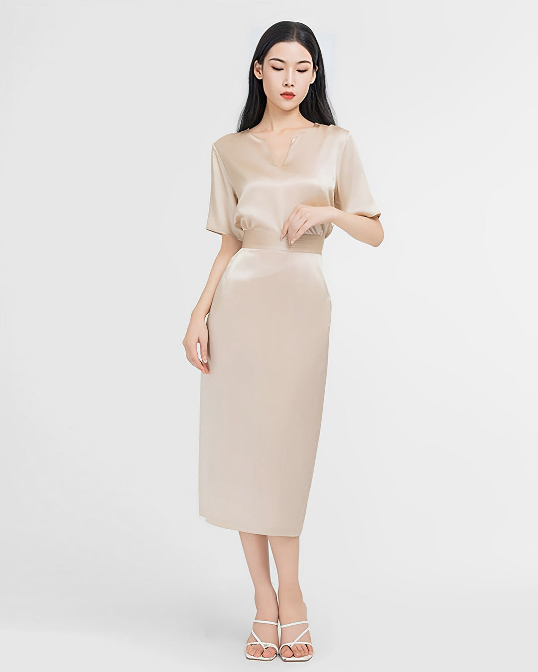 A woman with long hair is wearing the Elegant Two-Piece Silk Dress Set by SusanSilk, paired with white strappy heels and standing against a plain white background.
