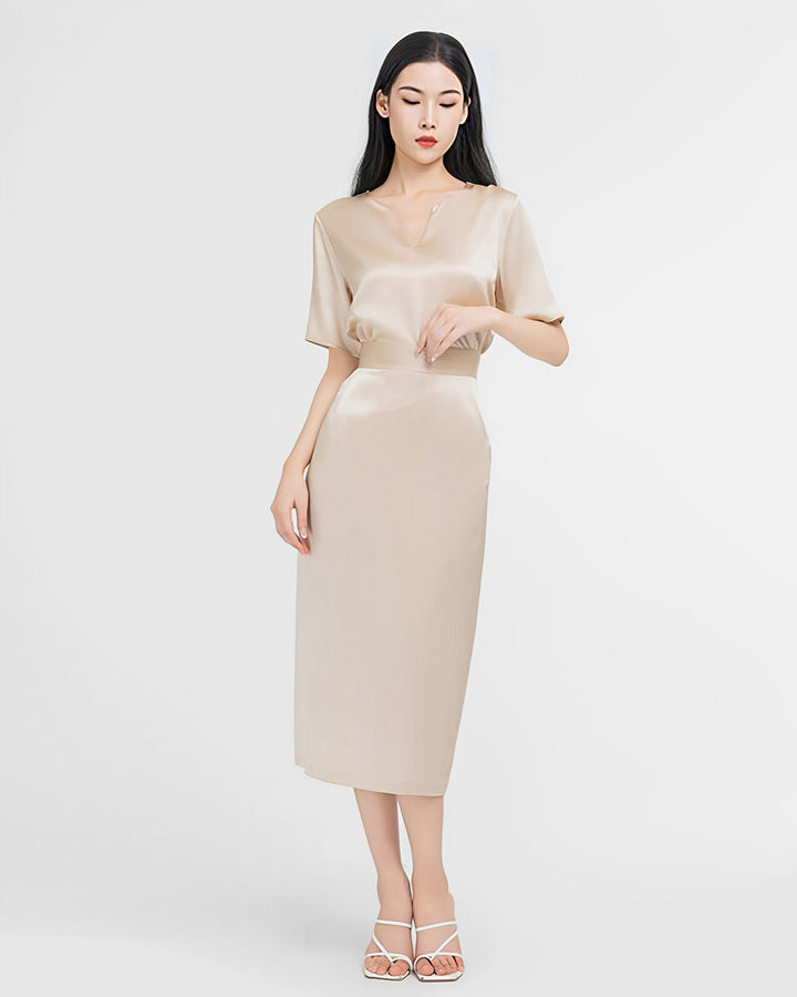 A woman with long hair is wearing the Elegant Two-Piece Silk Dress Set by SusanSilk, paired with white strappy heels and standing against a plain white background.