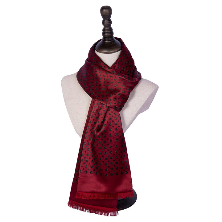 A SusanSilk Geometric Pattern Long Silk Brushed Scarf in Garnet displayed on a white mannequin bust.