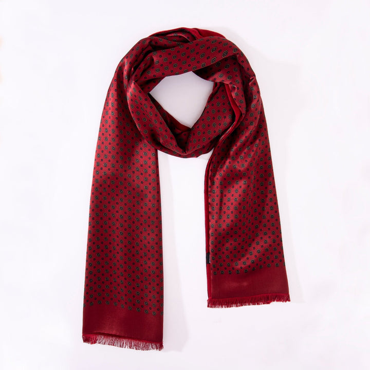 Geometric Pattern Long Silk Brushed Scarf - Garnet, loosely draped on a white background. This scarf, crafted by SusanSilk, features small black dot patterns and has fringed edges on both ends.