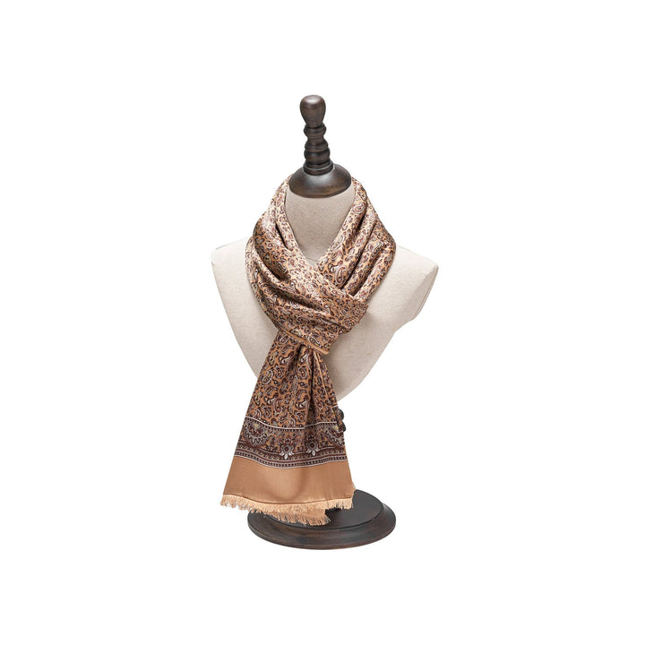 A beige and brown patterned scarf with fringe edges, crafted from luxurious SusanSilk, displayed on a mannequin bust.